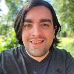 Image of Amedeo DeCara standing in front of trees.