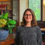 woman standing in reading room of library