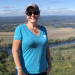 image of aime degrenier in blue shirt on mountain