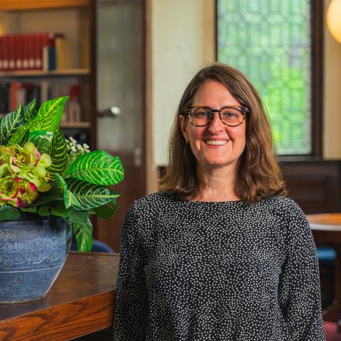 woman standing in reading room of library