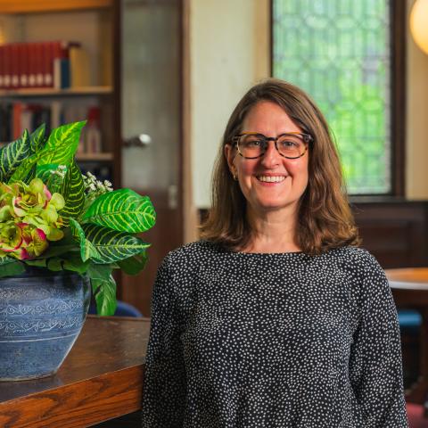 woman standing in reading room of library